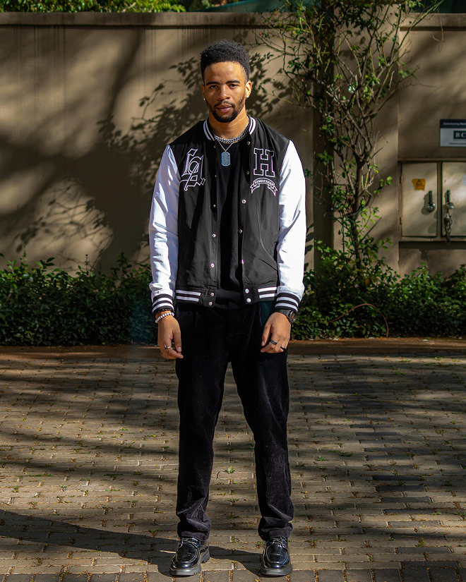 Man in a black and white letterman jacket with black pants — urban fashion virtual try-on