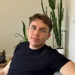 Portrait of Sarunas, founder of Ask My Wardrobe, sitting indoors for the contact page, representing the person behind the virtual try-on clothes platform and customer communication