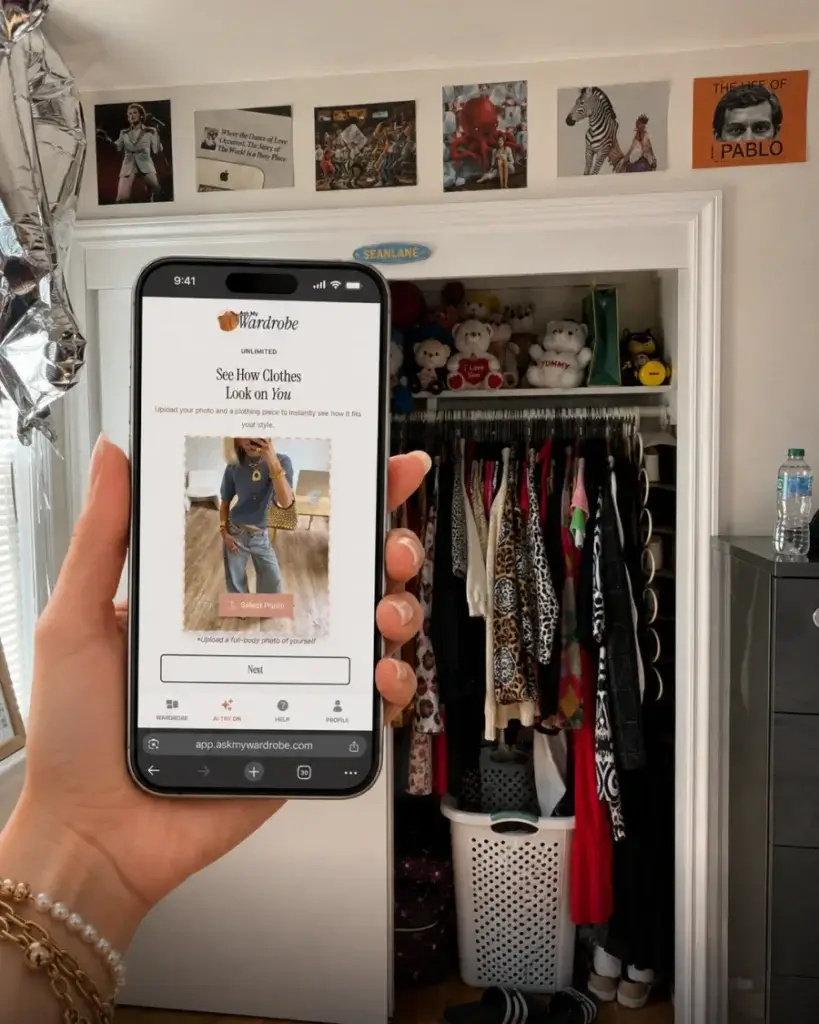 Person using the Ask My Wardrobe app in front of a closet full of clothes to preview outfits before buying, helping build a wardrobe of pieces they will actually wear instead of leaving unused in the closet.